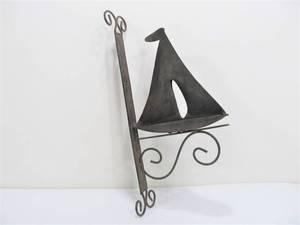 lot 280 image: Metal Sailboat Wall Bracket or Outdoor Bell Hanger