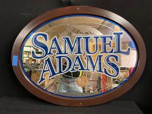 lot 130 image: Sam Adams oval mirror in wood frame