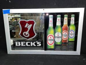 lot 139 image: Becks mirror with 4 bottles