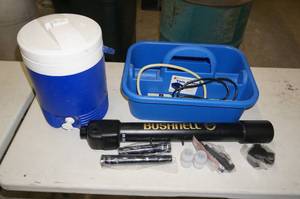 lot 55 image: Bushnell Telescope with a Igloo Water Jug