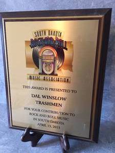 lot 31 image: Dal Winslow of The Trashmen South Dakota Music Association Award Plaque From 2013