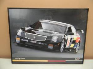 lot 57 image: CADILLAC RACING BREAK THROUGH PROFESSIONALLY FRAMED PRINT - NICE PIECE - APPROX 24 BY 19 - SEE PICTURES