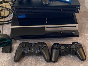 lot 54 image: Sony Playstation 2 and Playstation 3 Gaming Console and Controllers