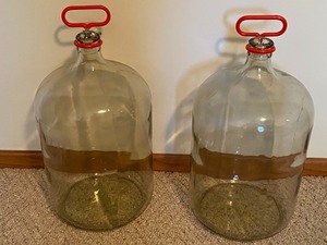 lot 255 image: Two Six Gallon Glass Jars with Holders