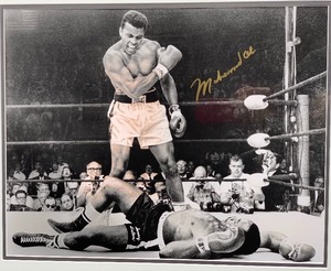 lot 4 image: Signed Muhammed Ali Stands Over Sonny Liston Photo, Framed with Certificate of Authenticity
