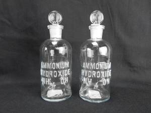 lot 167 image: Set of 2 Vintage T.C.W. Co. Ammonium Hydroxide Glass Bottles With Stoppers