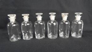lot 174 image: Set of 6 Vintage T.C.W. Co. 60 ML Narrow Mouth Clear Glass Bottles With Stoppers