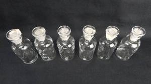 lot 175 image: Set of 6 Vintage T.C.W. Co. 60 ML Narrow Mouth Clear Glass Bottles With Stoppers
