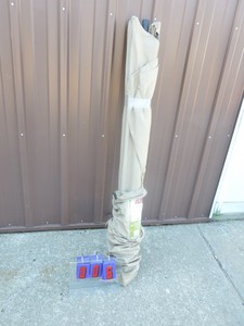 lot 6 image: 9 Light brown patio umbrella. New condition. Is missing bottom tube. As shown.