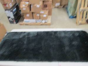 3 rugs black,brown and tan black is...