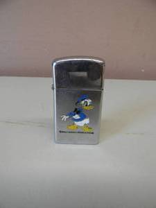 lot 99 image: VINTAGE 1976 WALT DISNEY PRODUCTIONS DONALD DUCK ZIPPO LIGHTER - RARE - SOME SELLING FOR OVER $1000.00 - AWESOME PIECE - PLEASE SEE PICTURES