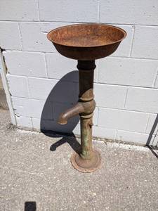 lot 107 image: Antique Well Pump made into Plant Stand  Yard Art