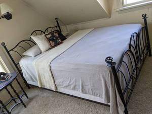 lot 122 image: Black Wrought Iron Queen Bed Frame w Bedding