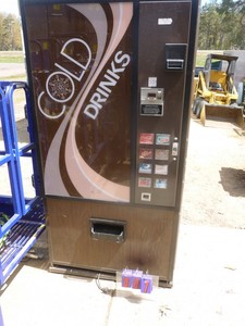 lot 7 image: Dixie-Narco 8 selection pop machine. Compressor runs but may needs a freon top off. No coin mechanism or lock. As shown.