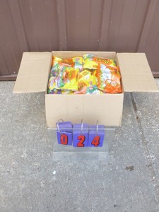 lot 24 image: Approx 25 lbs of assorted candy. Some may be out of date. As shown.