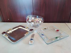 lot 223 image: Matching glass bowl, glass plate, metal plate, and cheese knife with other miscellaneous platters, ornaments, and a trivet