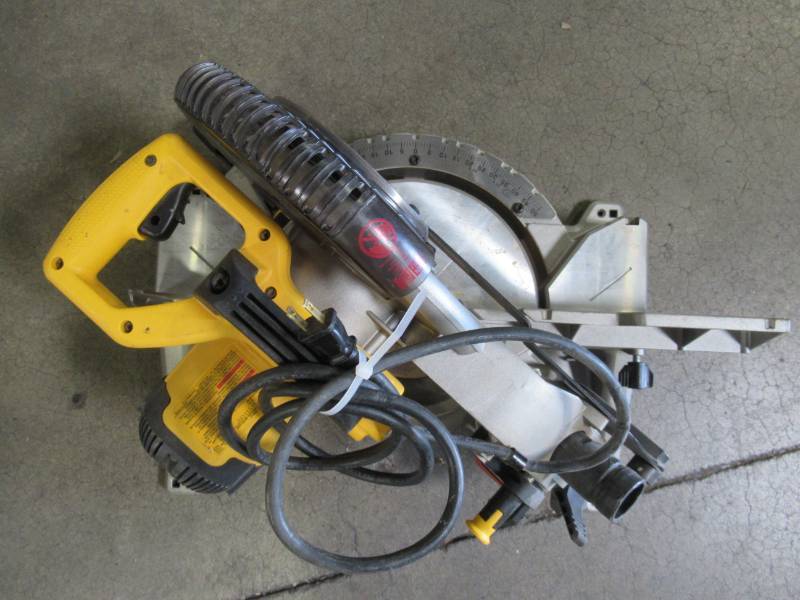 lot 68 image: DEWALT 10 in. 15 Amp Compound Miter Saw, DWS713. Used. Missing minor parts - Works.