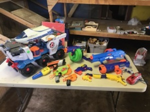 lot 1947 image: Lot of (11) Toys  - Nerf Guns (x7), RC Toy Car with Ship (makes sound), Nerf Dog Tennis Ball Gun, Hot Wheel Toy Gun, Fisher Price Light