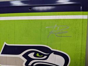 lot 17 image: Russell Wilson & Percy Harvin Autographed Seattle Seahawks Tin Sign NFL QB WR
