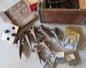 VINTAGE BOX FILLED WITH MOWER BLADES, GUARDS AND NEW BLADES