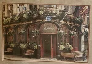 Framed print of a corner caf with blooming flowers
