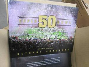 lot 550 image: Celebrating Fifty Years of Americas Greatest Game Super Bowl 50 Book by Bethany Bradsher (case of 10 books)