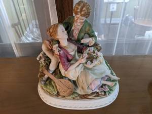 Vintage Figurine Boy Holds Girl in Restful Repose