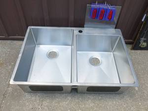 Stainless steel dual compartment sink. Looks like it may have been a store display As shown.