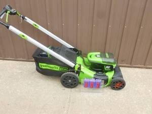 Greenworx 60 volt lawn mower with battery & charger. Nearly new. Tested & works. As shown.
