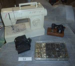 working Singer sewing machine with various stitches, a container full of buttons sorted by color, and a play holly hobbie sewing machine