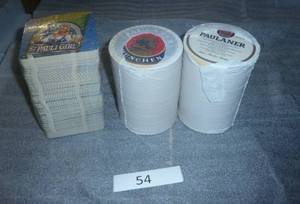 3 stacks of beer coasters, Paulaner and St Pauli Girl, each stack is probably 250