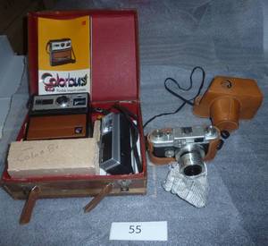 Old Kodak instant camera and a 35mm SLR with nice leather case