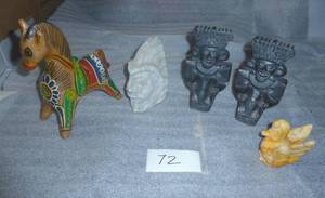 a somewhat ecclectic group,  metal horse bank, stone face and stone bird, not sure if the bookends are stone or resin