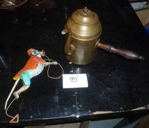 a couple of unique collectibles, teapot with a side handle and a tin climbing monkey