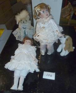 New in box porcelain doll with her dog pulling on her dress, another porcelain doll and a bear with lace dress