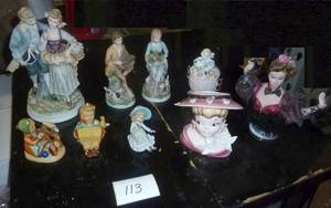 group of figures including a head vase and hummel