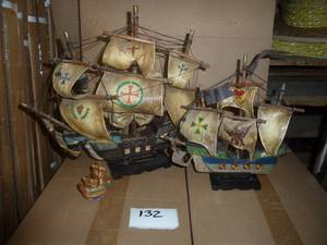 Two vintage sailing ships, the Albatross and the Mayflower.  I am not sure if the sails are made of a fabric with lacquer or if they are leather.