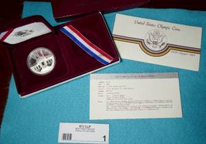 1984 US Olympic Silver Dollar.  .86 troy oz (77 silver, 09 copper)