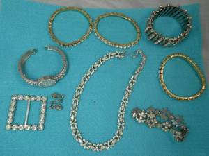 Group of rhinestone jewelry, bracelets, watch (needs battery), necklace and belt buckle all in good condition, one of the 3 thin bracelets is missing one stone.