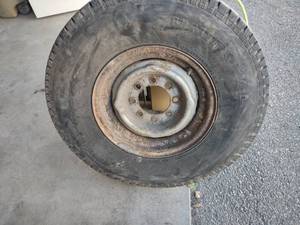 lot 667 image: 8 Bolt Rim & Tire LT23585R16...