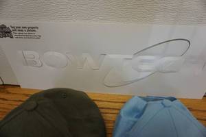 lot 93 image: Bowtech Decal With Vane Tec Precision Arrows and Light Blue Baseball Caps