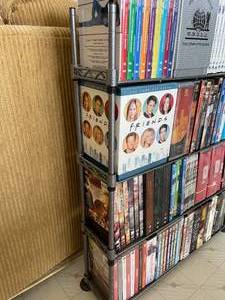 lot 98 image: Large Lot of TV Series DVDs on Metal DVD Stand