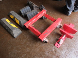 lot 233 image: WHEEL CHOCKS, WHEEL DOLLY AND WHEEL VISE