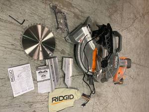 lot 110 image: 15 Amp Corded 12 in. Dual Bevel Miter Saw with LED by RIDGID Customer Returns See Pictures