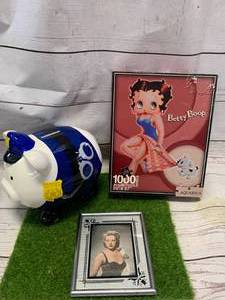 lot 35 image: Police Piggy Bank, Betty Gable Photo, Betty Boop Puzzle