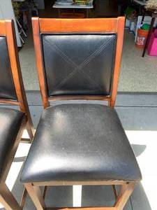 lot 241 image: Two bar height bar seats, wood with black cushioned seats and backs