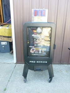lot 4 image: Pit Boss pellet smoker. Pellet cover was damaged in shipment  otherwise appears new & unused. As shown.