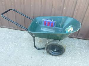 lot 5 image: Yard Rover plastic wheel barrow. Has a few scratches but appears unused. As shown.