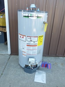 lot 9 image: A.O. Smith 40 gal short gas water heater. Shipping damage on metal shield. Otherwise looks new & unused. As shown.