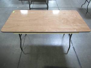 lot 94 image: Table With Folding Legs, Approximate Dimensions 60 x 29 12 x 30 12 Tall. - Top is Scratched.